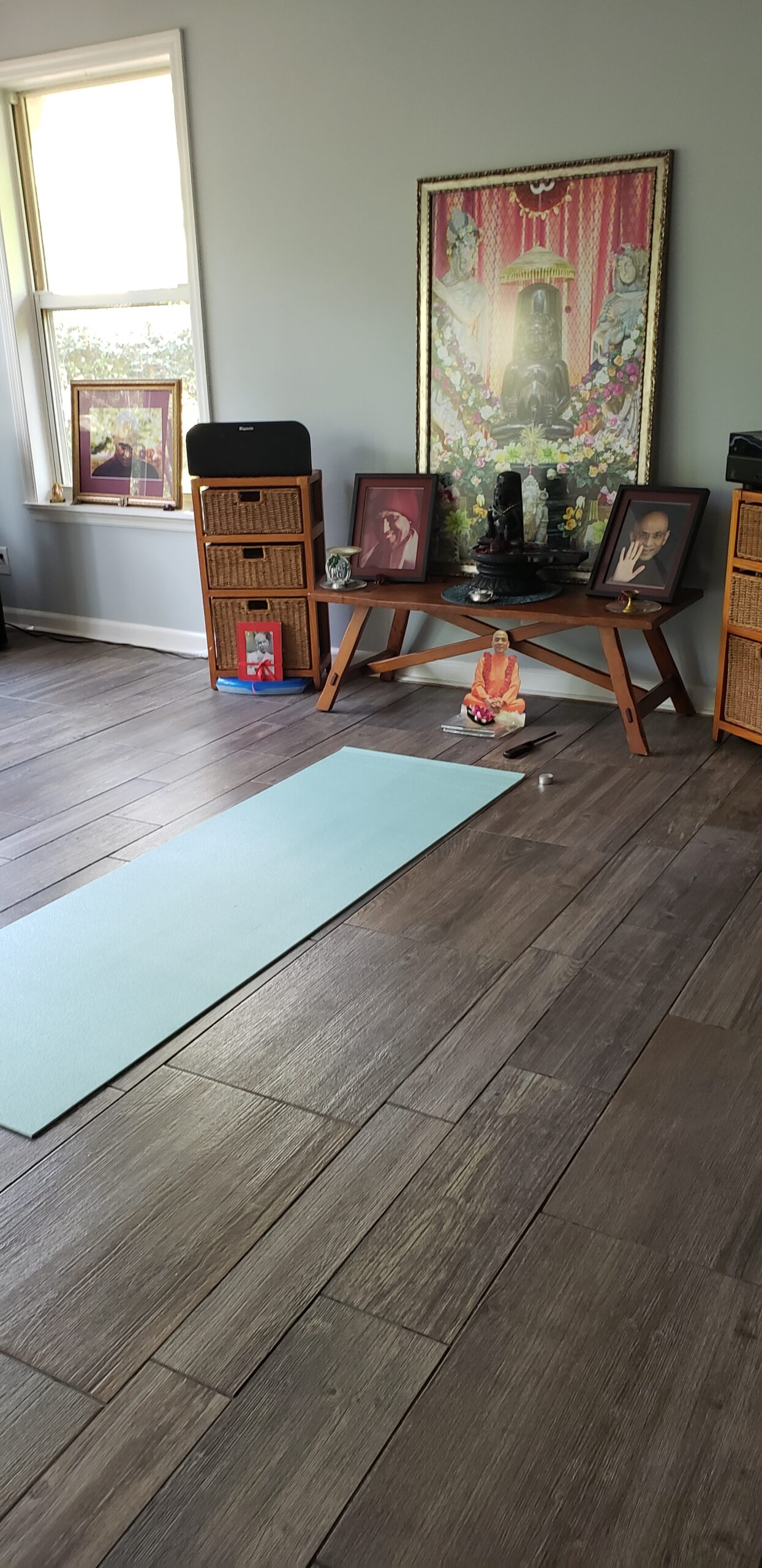 Photo is decorative. When touring a home, buyers like to see lots of floor space. This photo shows a yoga mat on the floor in front of an altar. Floors are bare wood.