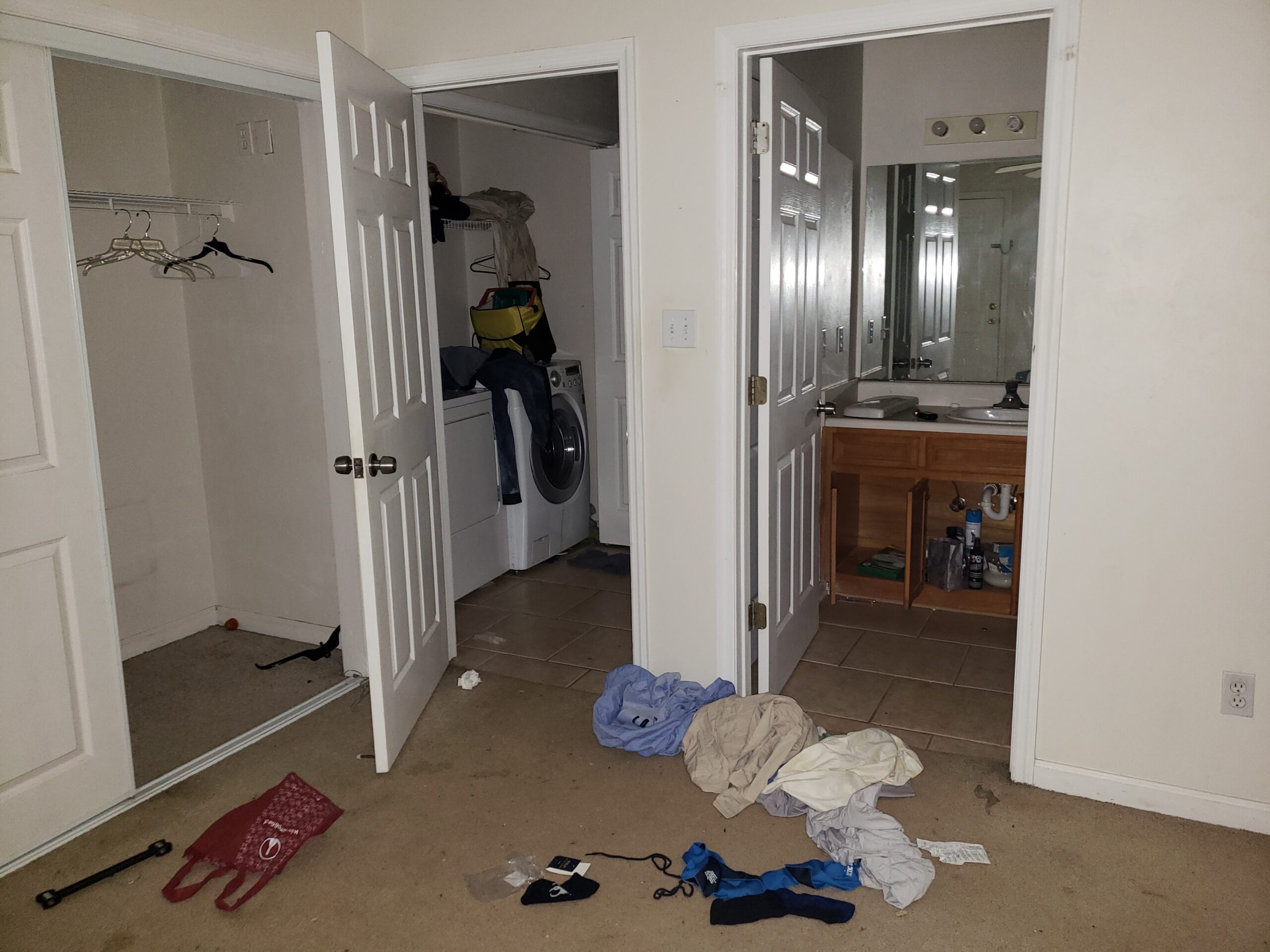 Photo is decorative. It shows a master bedroom with clothes and debris left on the floor and stuff piled on the washer dryer. Tallahassee Realtors should ask you to clean that up!